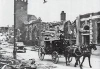 The Sheriff's Coach passes the bombed out wreck of the church