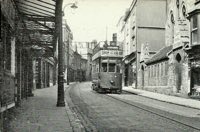 A tram passes the canopy of the Palladium Cinema