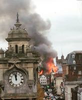 The Clocktower, Rougemont Hotel and Cathedral as flames leap up from the Royal Clarence Hotel