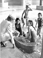 Princess Diana talking to youngsters in the pool