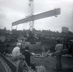 A crowd watches the work