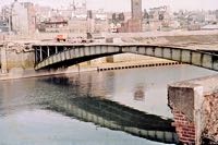 This photo shows the two half arch construction of the bridge during demolition