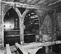 An internal oak screen before the Priory was restored.