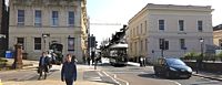 A tram trundles down Queen Street