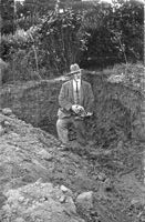 An archeologist holds an excavated skull.