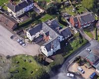 The Google Earth view shows the various wings of the building