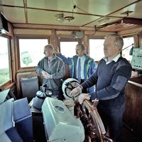 Skipper Ron Gardner at the wheel